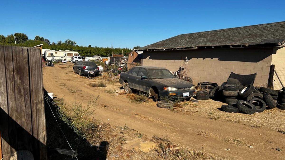 A broken down car and piles of tires are seen in this photo of a property at the center of dozens of 911 and code enforcement calls in the Prosser area of Benton County. Pit bulls from the property were seized for a vicious attack on a mother and 15-year-old son in April 2022.