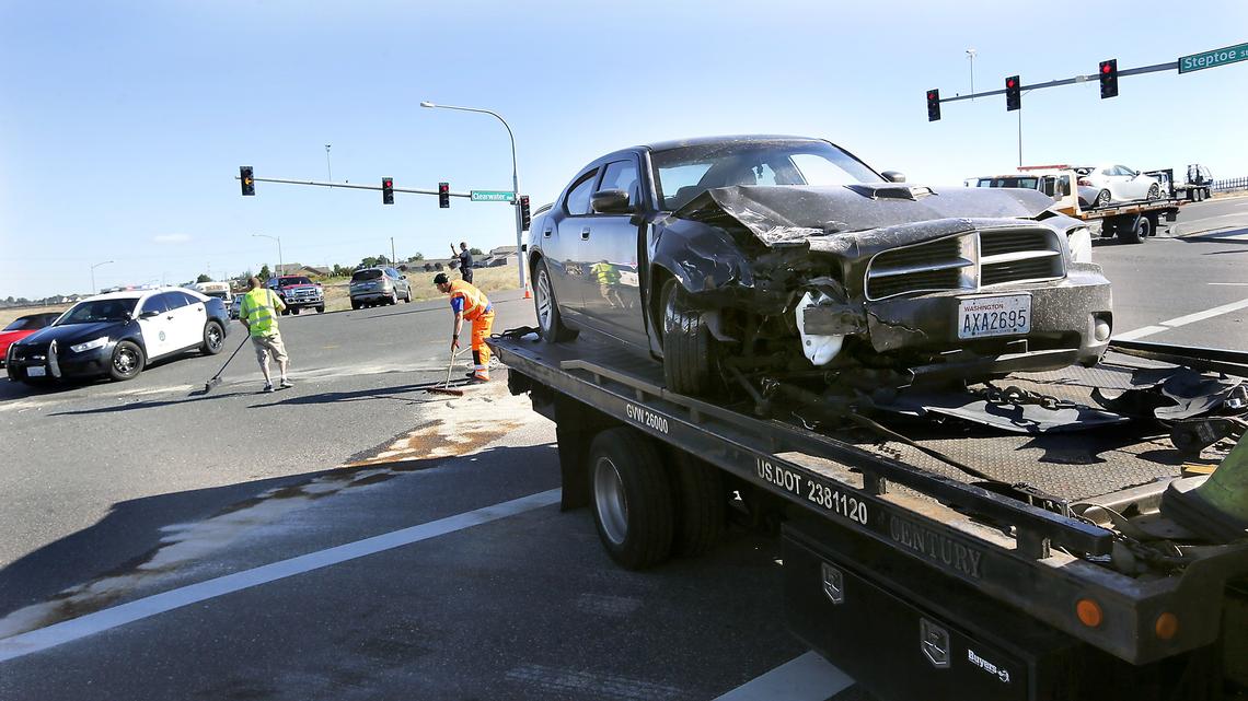 Tow truck operators clean up at the scene of Monday morning's two vehicle collision at the intersection of West Clearwater Avenue and Steptoe Street in Kennewick. Police say driver Russell Dodson, 27, of Kennewick was eastbound on Clearwater Avenue in a 2016 Dodge when it slammed into the back of a 2016 Lexus being driven by Lucien Megna of Kennewick. Megna, also eastbound, was stopped for the traffic signal. Officials said Dodson was in a seizure when officers arrived. They are investigating if he suffered from a medical problem while driving.
