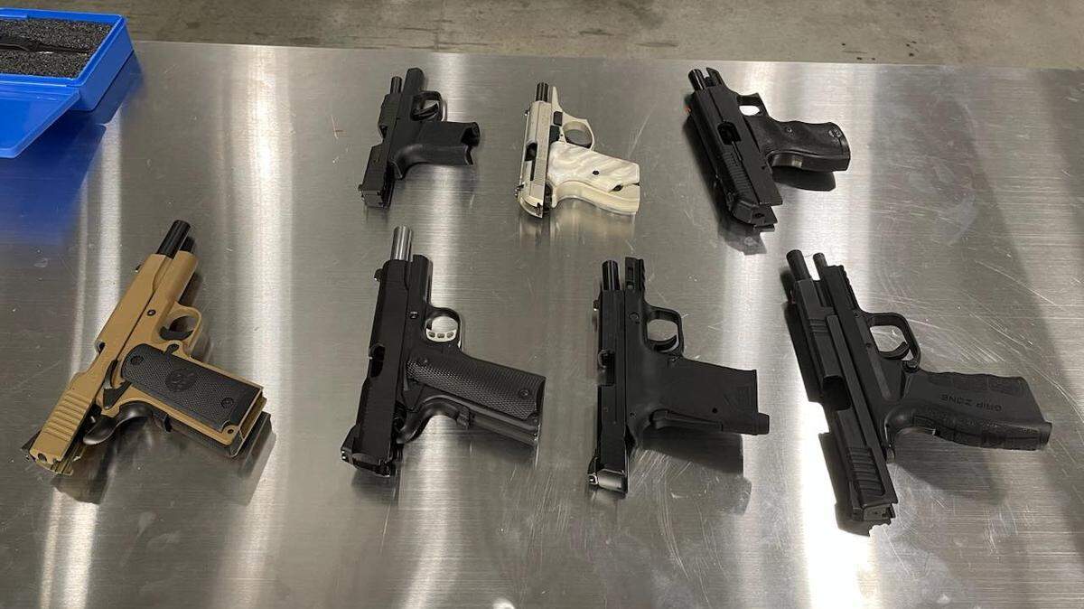 Pasco police found seven guns after an alleged shooting outside of a Irving Street home in August. A father and son have been arrested for the crime.