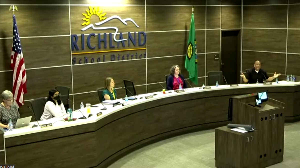 Richland School Board member Semi Bird, right, speaks with unruly attendees (off screen) at a public meeting on Tuesday, April 26. On the agenda was an item to discuss paying legal fees for three of the board members’ recall elections.