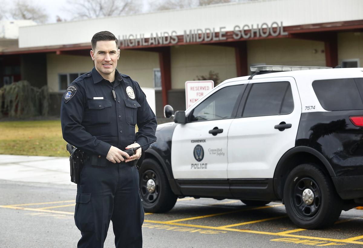 School Resource Officer Tim Harris, with the Kennewick Police Department, stands in front of Highlands Middle School in Kennewick. The city is setting aside money in its 2019-20 budget to help pay for for officers at all five middle schools. Watch a video at: tricityherald.com/video