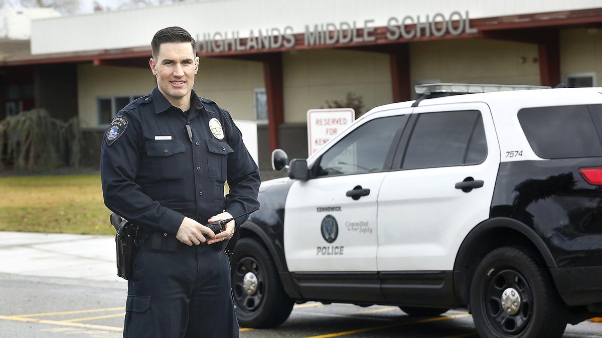 School Resource Officer Tim Harris, with the Kennewick Police Department, stands in front of Highlands Middle School in Kennewick. The city is setting aside money in its 2019-20 budget to help pay for for officers at all five middle schools.