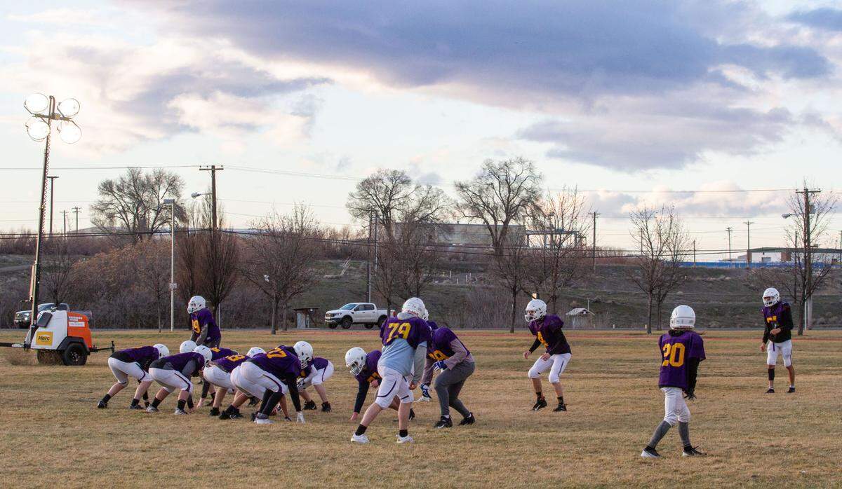 The Hanford High School Falcons football team runs drills on their practice field off of George Washington Way for the upcoming abbreviated spring 2021 football season that begins Feb. 26.