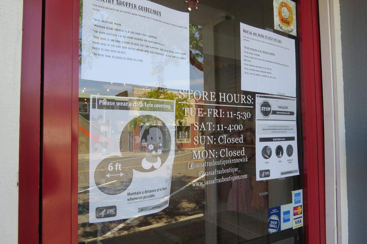 Sassafras Boutique in downtown Kennewick posted signs about the guidelines they need to follow and are following to keep people safe.