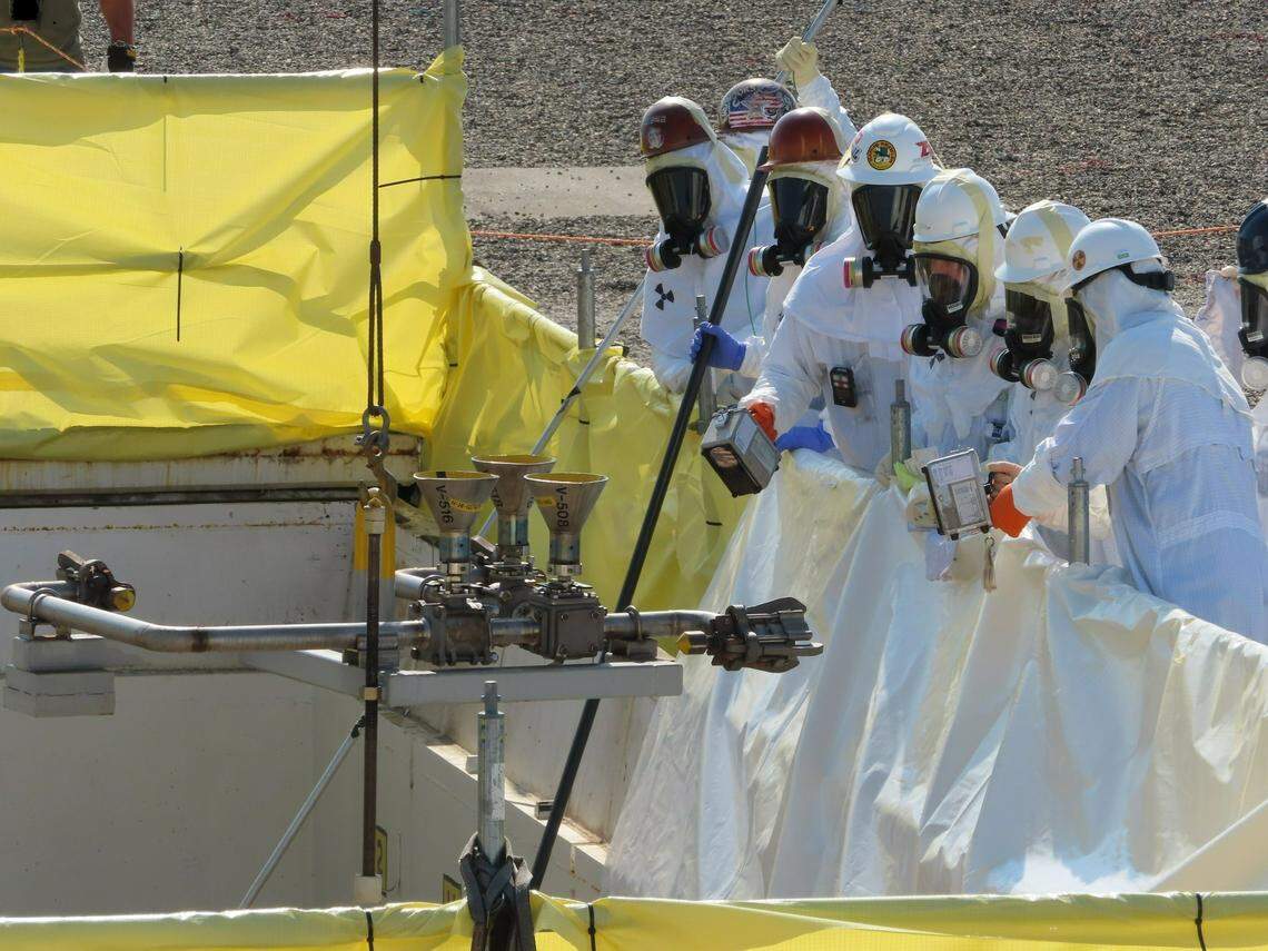 Workers with tank operations contractor Washington River Protection Solutions, owned by Amentum, remove equipment no longer needed from the AP Tank Farm valve access pit.