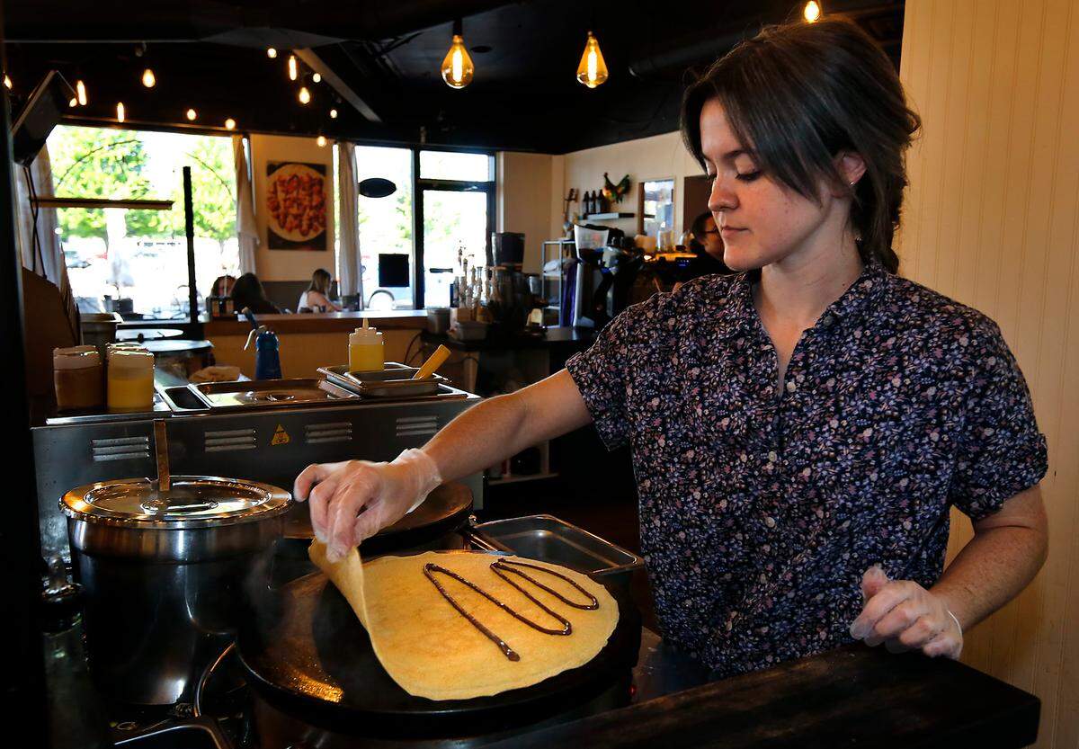 Emily Colby, store manager at Kagen Coffee & Crepes, cooks a Nutella strawberry banana crepe recently in the Uptown Shopping Center location in Richland.