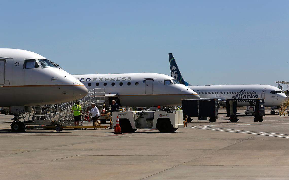 Passenger jet planes sit on the tarmac at the Tri-Cities Airport as they prepare to depart from Pasco.