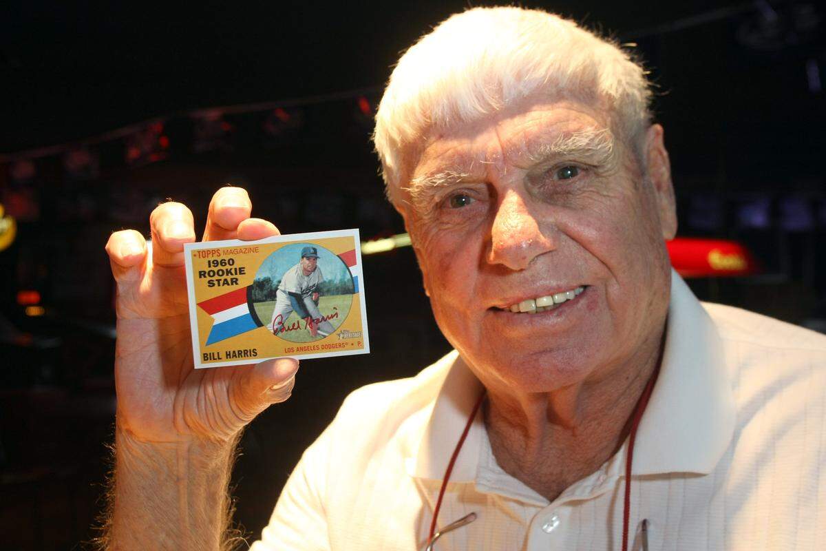 This 2009 Herald file photo shows Billy Harris holding his Topps Heritage baseball card. He died in 2011 at age 80.