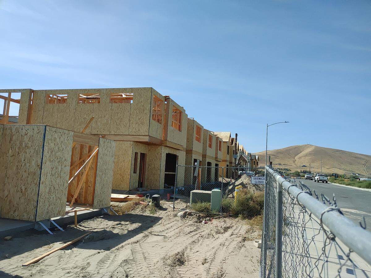 Red Mountain looms over townhomes being constructed by MWIC Northwest TH LLC, an arm of Ranchland Homes, at Keene and Albion in West Richland. Photo taken September 2024.
