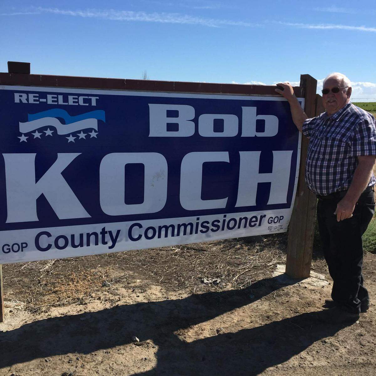 Former Franklin County Commissioner Bob Koch stands next to a campaign sign.
