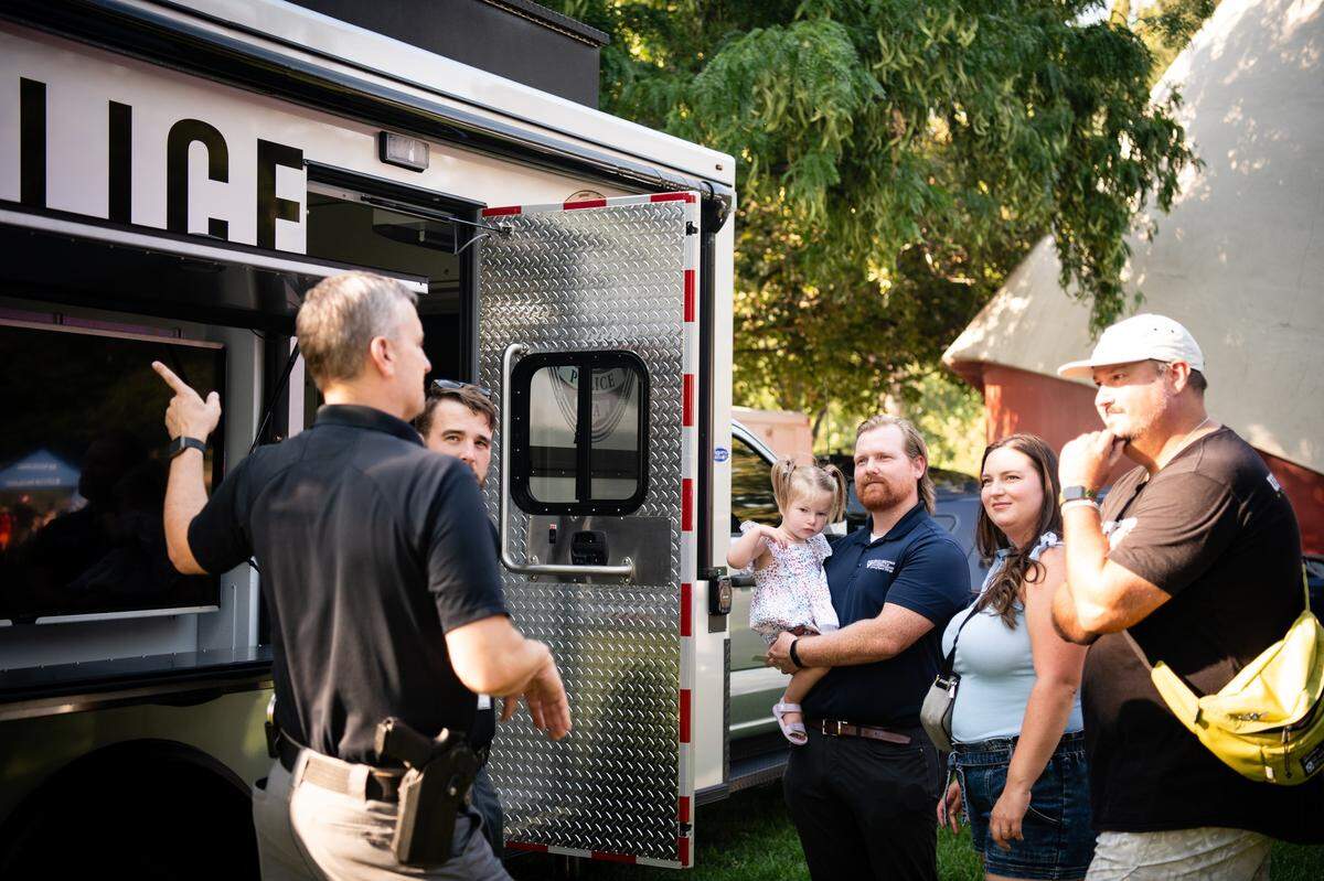 Richland police officers talk to a group of people at the National Night Out event at Howard Amon Park in 2024.