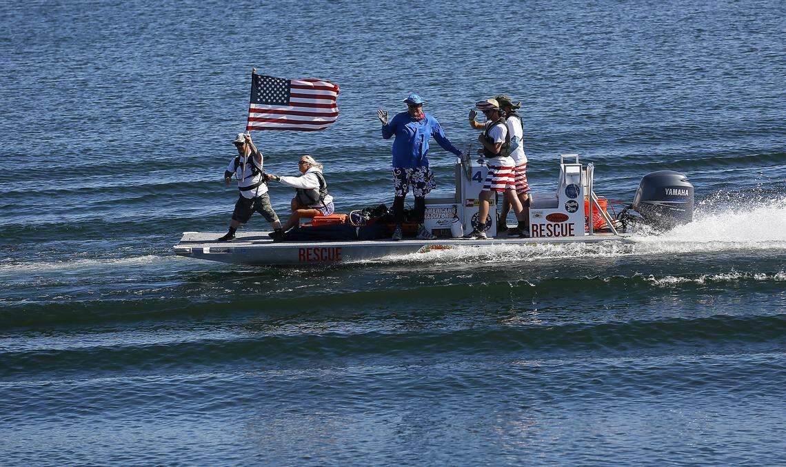 Members of the Tri-Cities Water Follies rescue teams take part in presenting the colors during the opening ceremonies for the Apollo Gold Cup in the Columbia River.