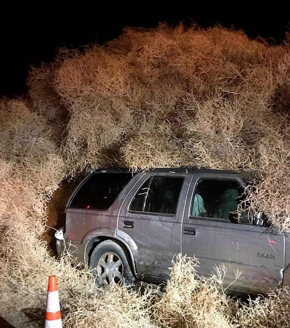 Wind-blown tumbleweeds cover a vehicle on Highway 240 northwest of Richland on New Year’s Eve.