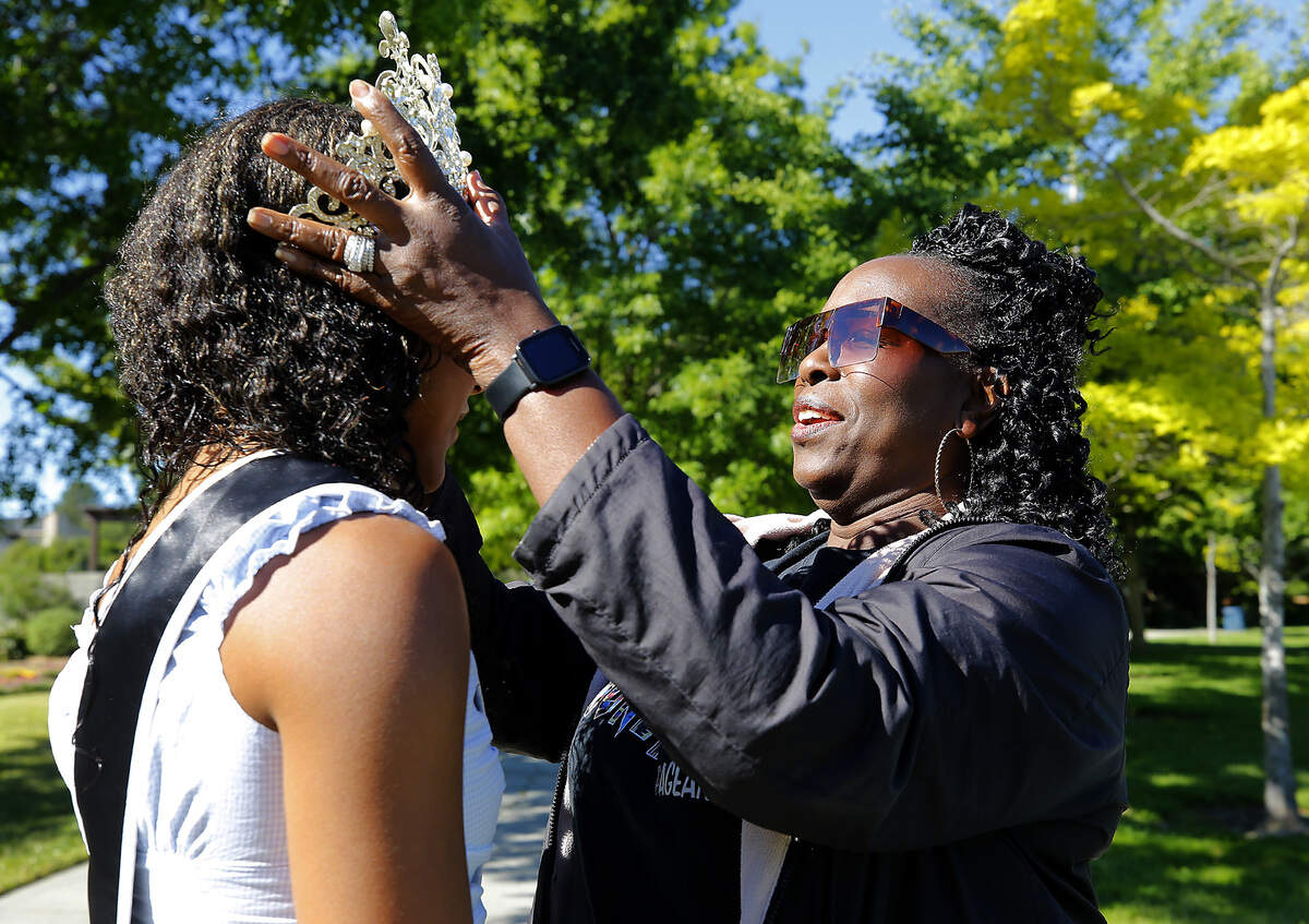 Sparks adjusts Oliver’s crown in Kennewick days before the 24th Miss Juneteenth pageant.