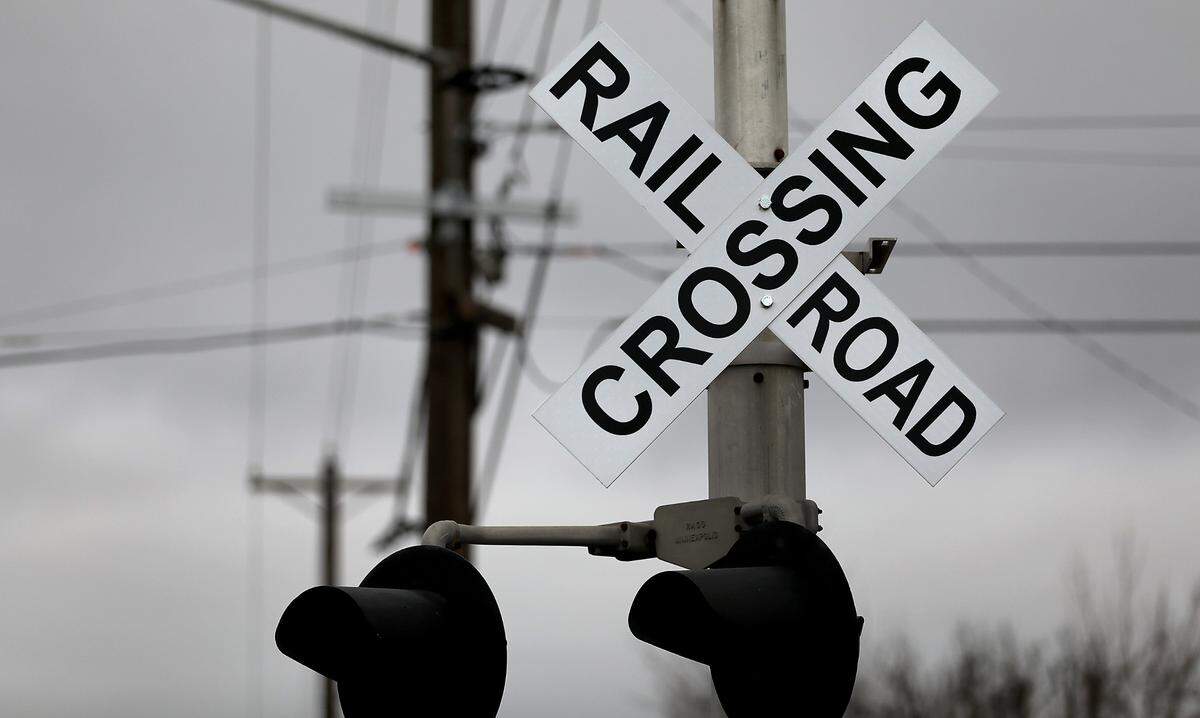 Railroad crossing sign on warning light pole on North Fruitland Street in downtown Kennewick.