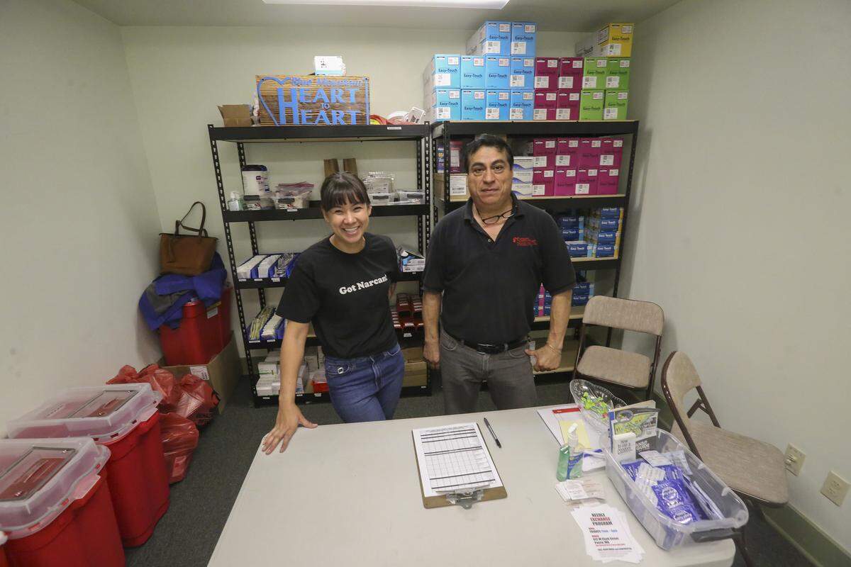 Blue Mountain Heart to Heart’s Melissa Cross and Raul Morales stand inside a small needle exchange room in Pasco. Cross and Morales are also a part of the Walla Walla-based outreach crew.