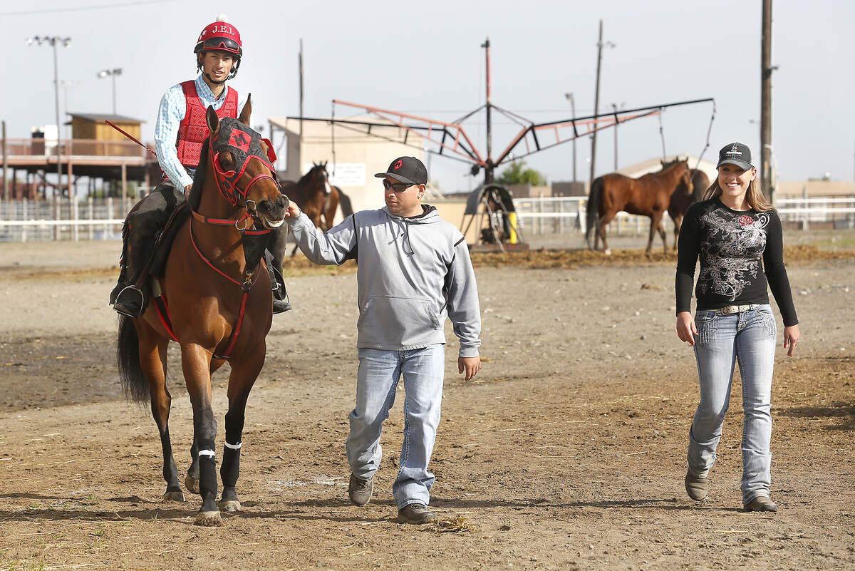 Trainer Hector Magallanes leads a horse named KR Olive Oil with jockey Jaime E. Lopez back to the stalls following a training run Thursday morning at the Sun Downs Race Track. Magallanes’ fiance Tryn Espelien walks along with them. Trainers and riders are busy preparing for this weekend’s start of the three weekend spring racing meet at the Kennewick track. Watch a video at: tricityherald.com/video