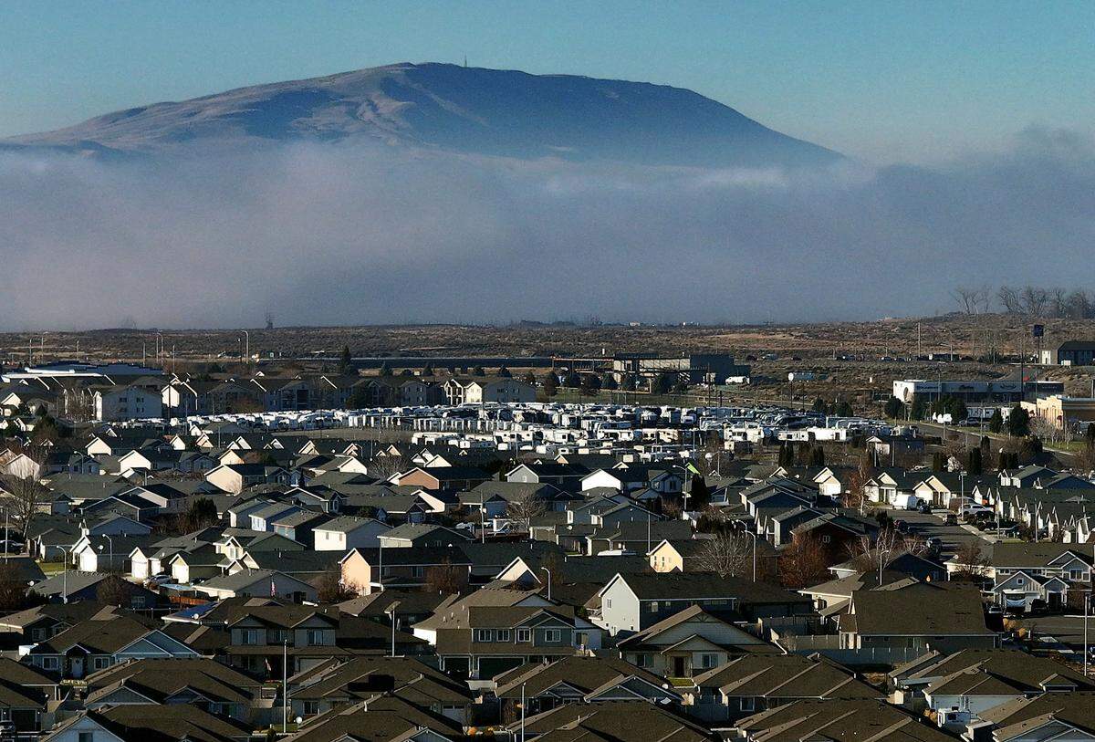 Rattlesnake Mountain looms large behind the housing development in west Pasco.
