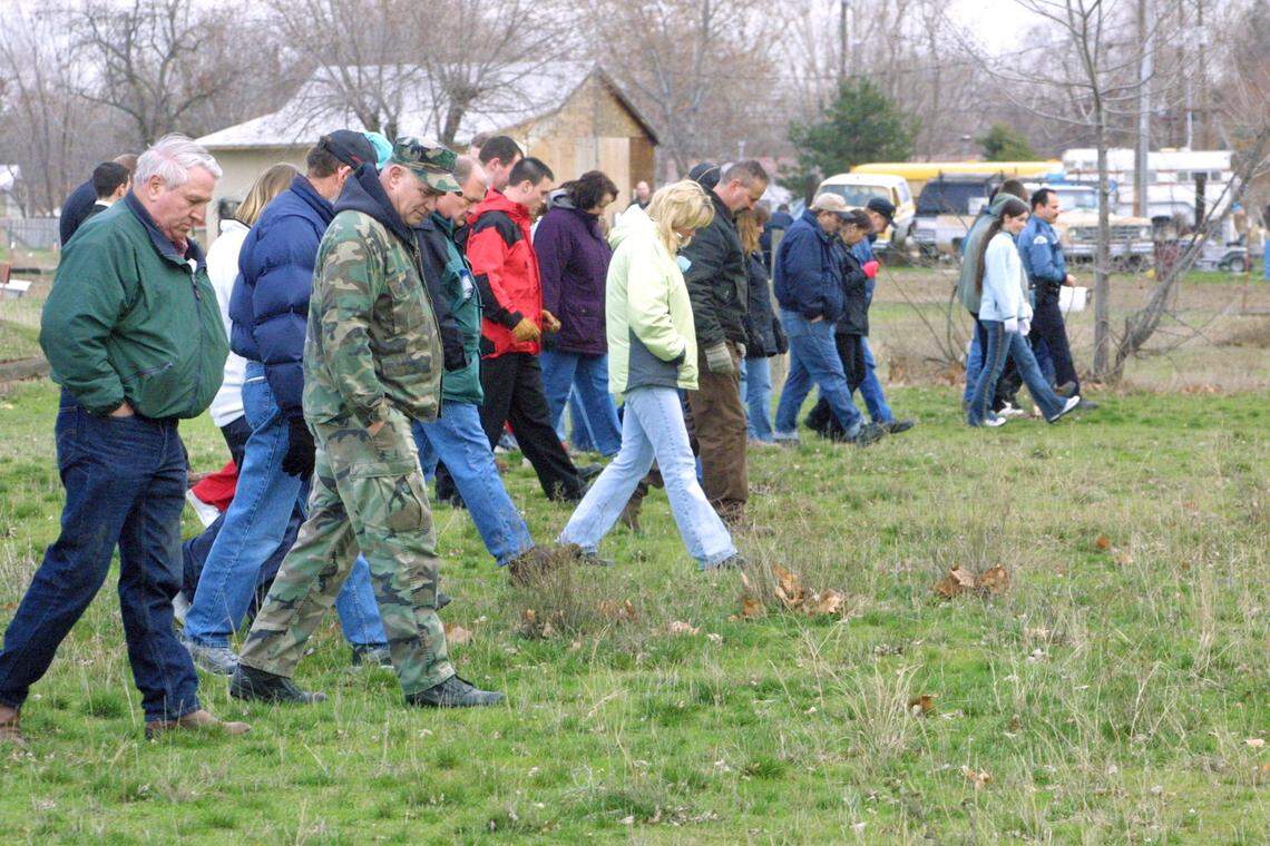 Volunteers and police officers line up shoulder to shoulder in a field off West 12th Place in Kennewick to search for clues the day after Sofia Juarez disappeared from her home Feb. 4, 2003.