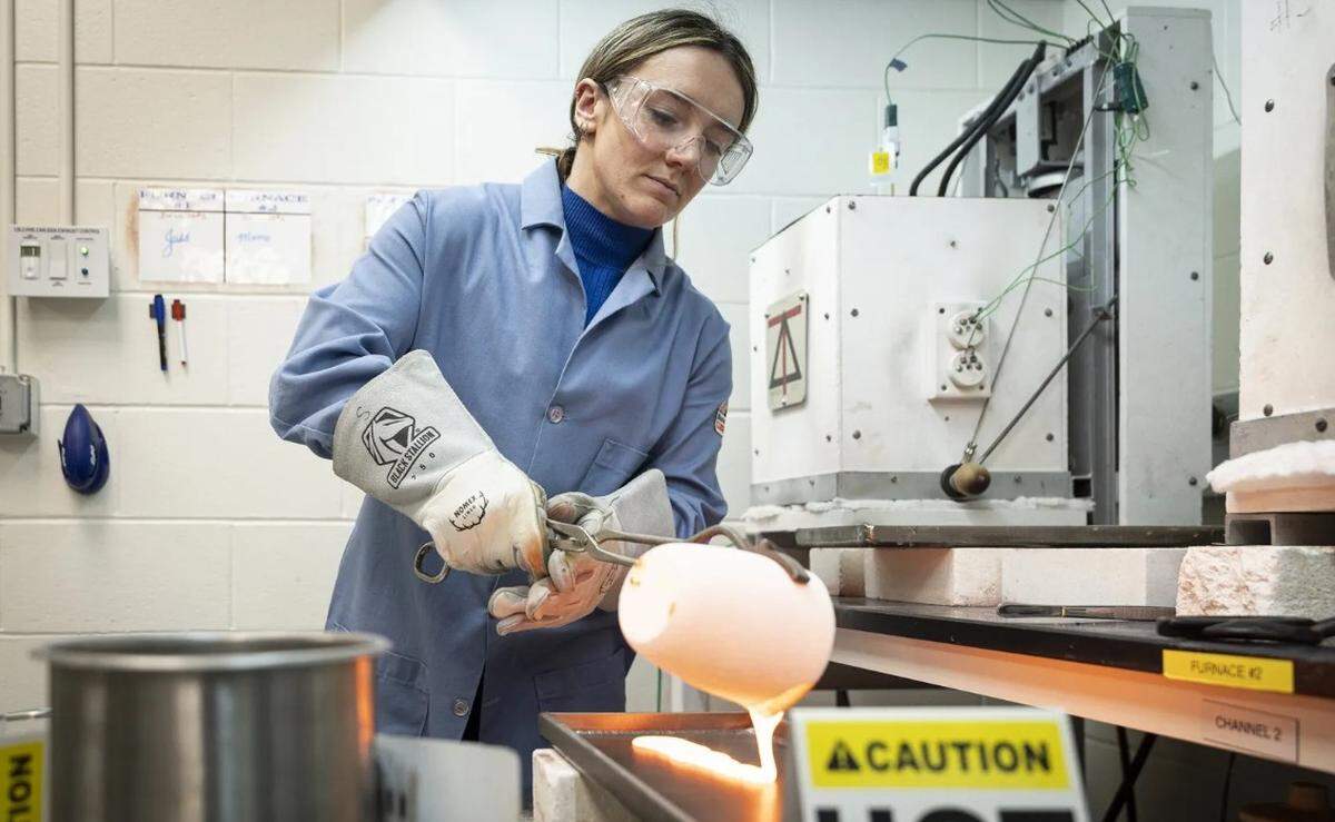 Jess Rigby, a materials scientist in the Wasteform Development Laboratory, pours a glass solution used to capture toxic material, at Pacific Northwest National Laboratory.