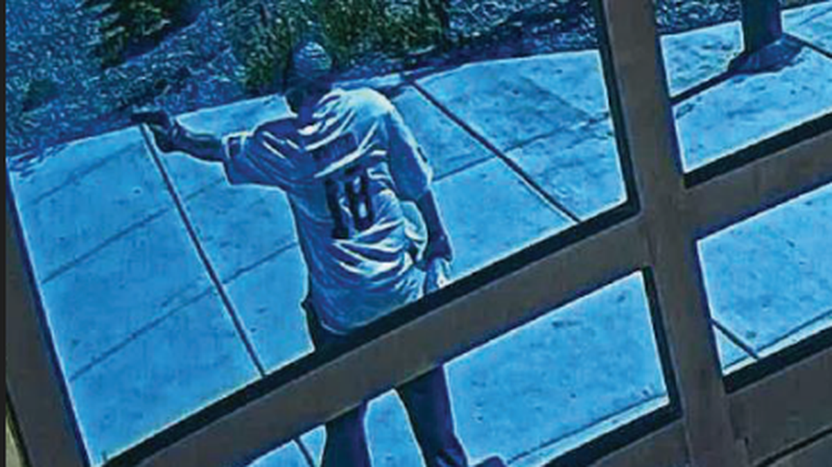 This image taken from security footage shows Wildhorse Casino robbery suspect Javier Francisco Vigil pointing a gun outside of the casino.
