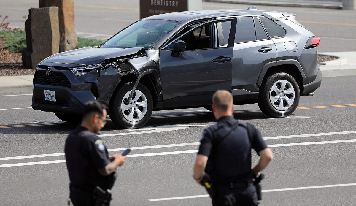 Kennewick Police officers investigate the scene of Monday morning’s fatal collision between a vehicle and pedestrian on West Gage Boulevard at North Louisiana Street. The damaged late-model Toyota Rav4 involved in the collision, where a 61-year old Kennewick man died, sits in the roadway following the incident.