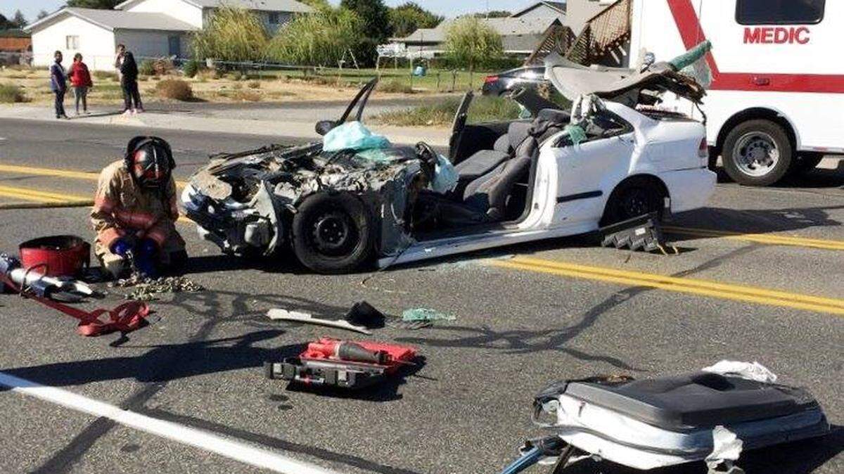 Pasco firefighters needed to cut a teen out of the remains of his car Wednesday after he slammed into a school bus. Police say he was racing another car at speeds of 90 mph on the city streets.
