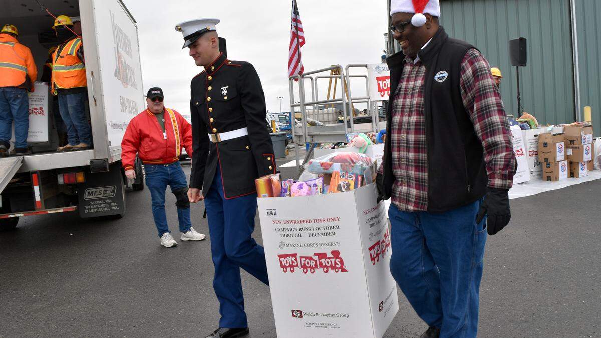 Team members at the Hanford vit plant gathered to donate more than $23,000 in toys and cash to the U.S. Marine Corps Reserves’ Toys for Tots and Local 598’s Bikes for Tikes campaigns.