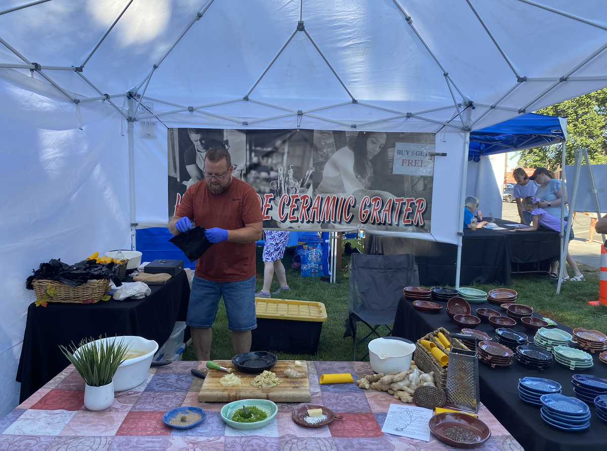 A vendor with Herb Ceramics works at his booth at Art in the Park in Richland.