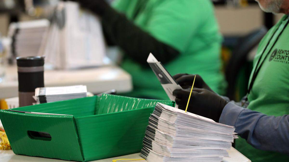 Benton County election workers open envelopes Tuesday morning to prepare the submitted general election ballots for tabulation at the Benton County Elections Center in Kennewick.