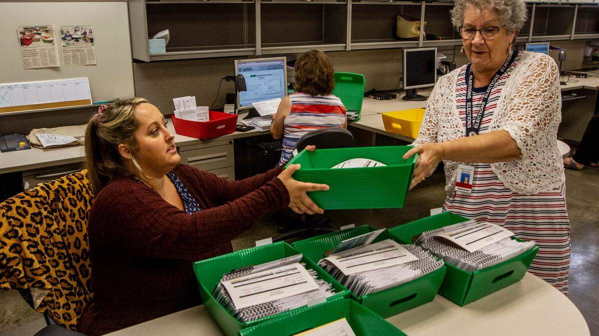 Franklin County elections workers sort primary 2021 ballots for counting.
