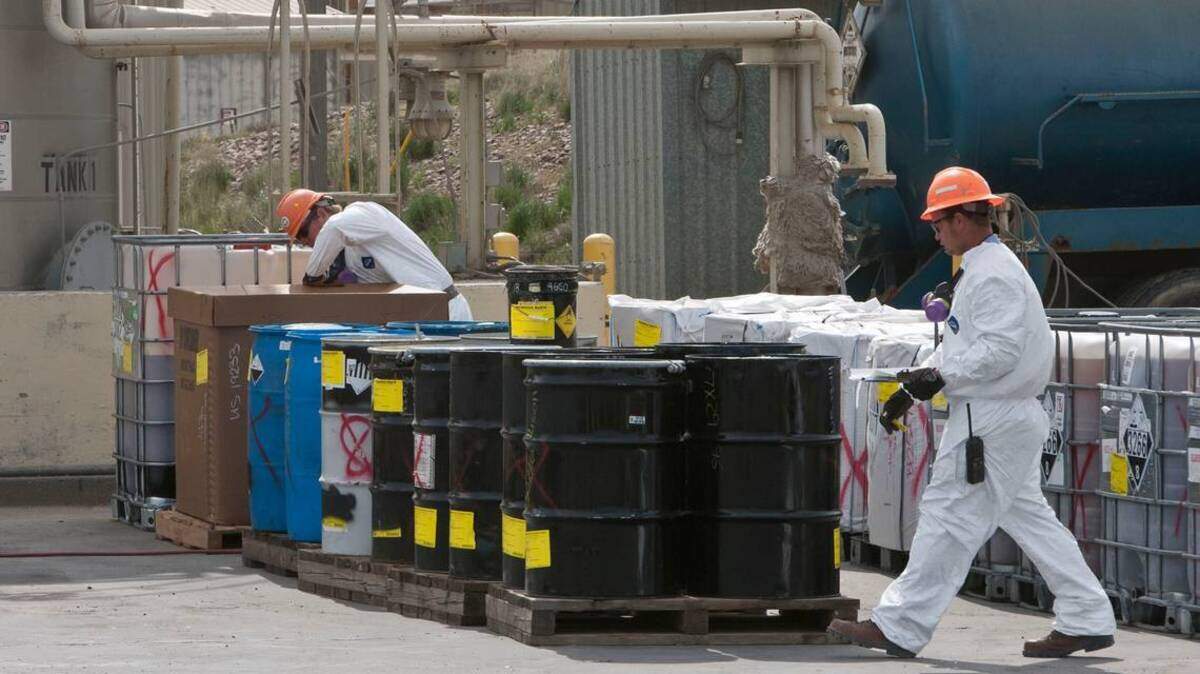 In this file photo, container management operators at US Ecology Idaho near Mountain Home catalog closed drums filled with various types of hazardous waste in a temporary storage area where new material is analyzed.