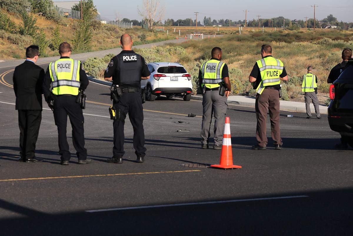 Richland police officers investigate the early Wednesday morning fatal collision involving a bicyclist and a car on Duportail Street at City View Drive. 