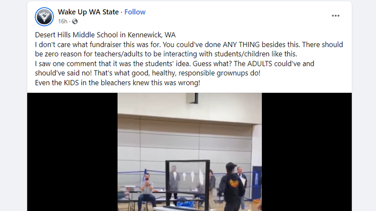A still image from a video posted on Facebook showing a Desert Hills Middle School assembly where staff and students lick whipped cream from both sides of a window.