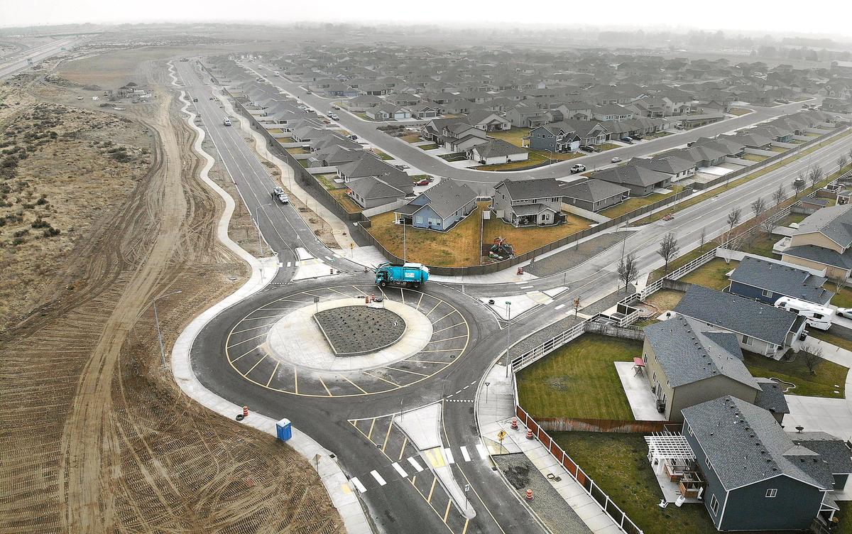 A garbage truck navigates the roundabout at Road 84 and Chapel Hill Boulevard in west Pasco.
