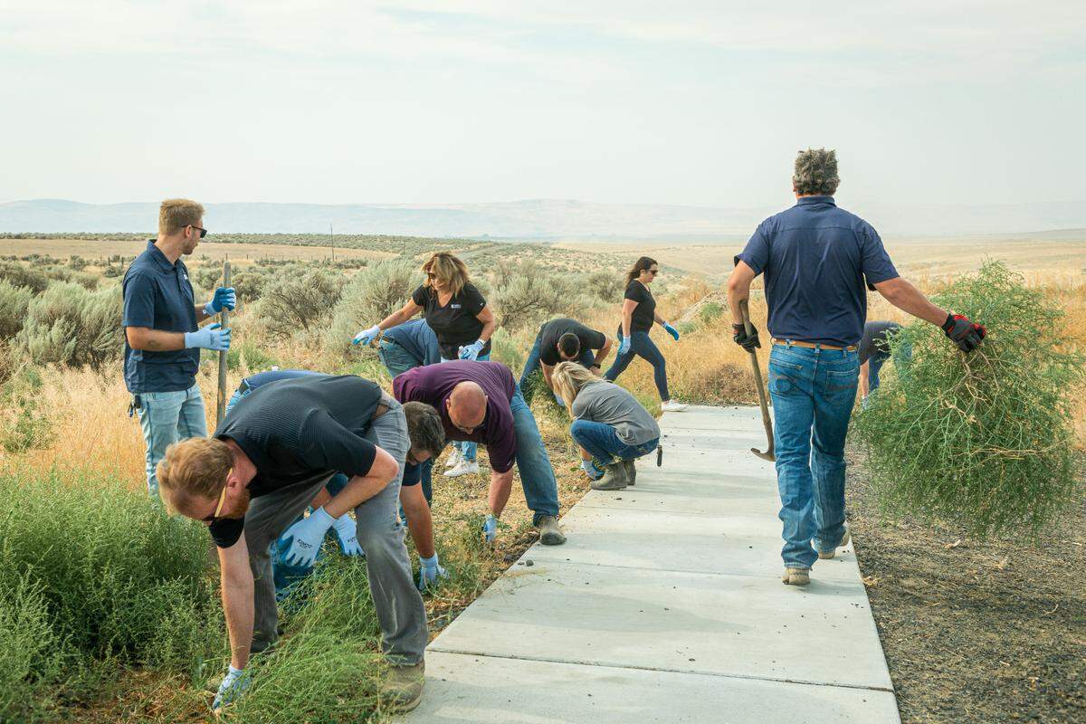 Volunteers with Hayden Homes work on pathways at the Ranch, a planned retreat being built by the Friends of Disabled Veterans.