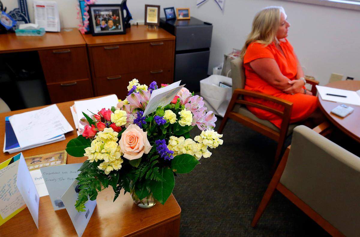 Flowers and cards sit on the desk of Traci Pierce, who retires at the end of the month from the Kennewick School District.