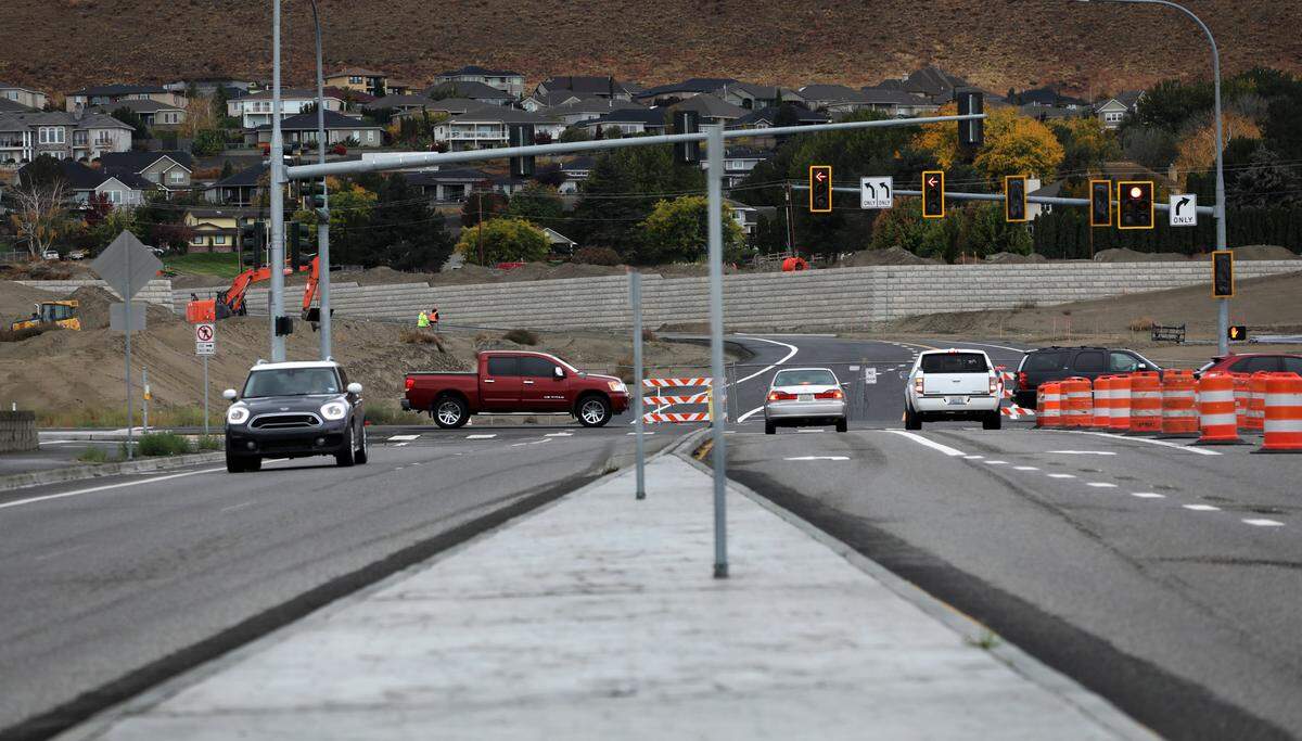 Traffic barricades and barrels block the new southern extension of Queensgate Drive at Keene Road in south Richland. The newly paved road leads to a new construction development and connects near Shockley Road.