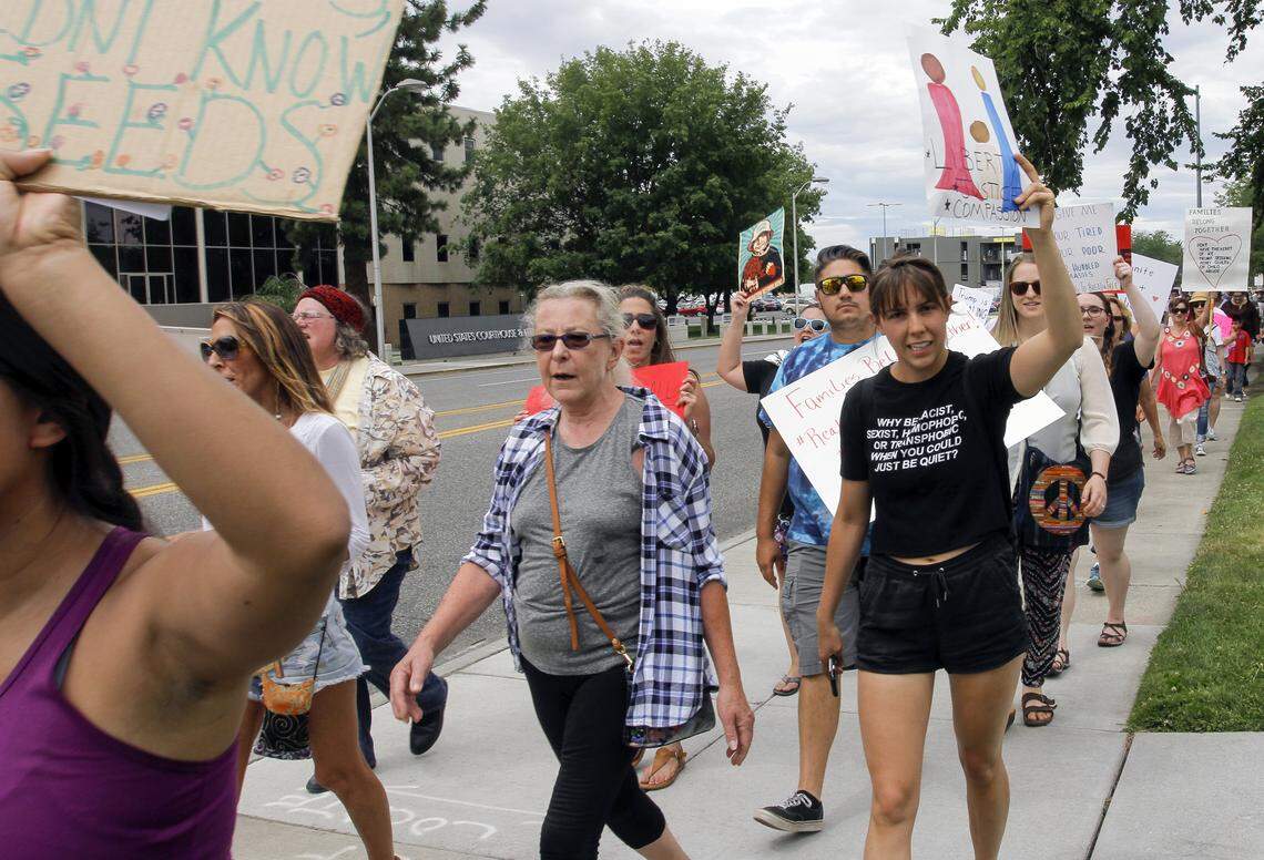 More than 200 people walked during a Saturday protest that started in John Dam Plaza in Richland. Protesters walked about a mile and a half holding signs and chanting against a federal policy that separates children from their parents at the southern border.