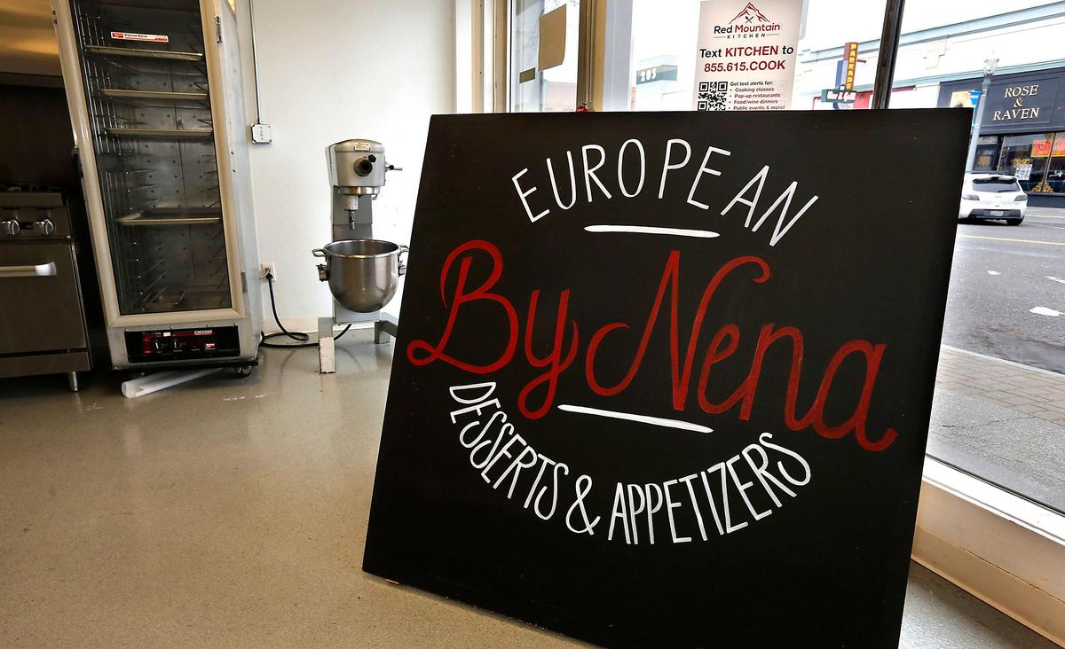 A sign inside the front windows of the Red Mountain Kitchen advertises for European Desserts & Appetizers by Nena in downtown Kennewick.