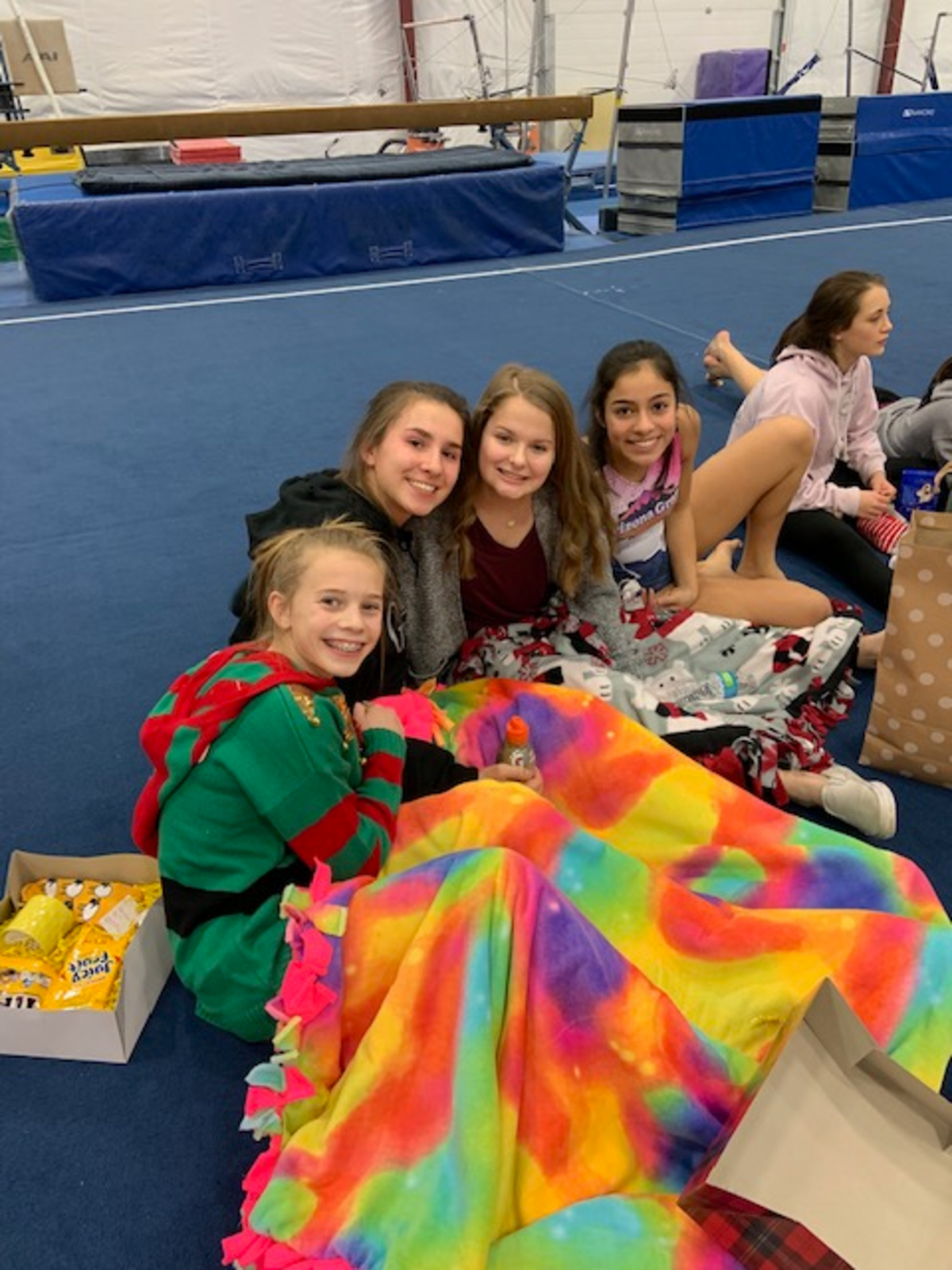 Emily Larson, center, reuniting with teammates at Garland’s Gymnastics in Kennewick after returning from treatment in Seattle.