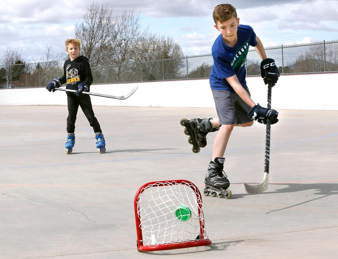 Jackson Rowland, 12, fires the puck into a mini practice net on a breakaway while playing with his brother, Ryan, 10, at the outdoor roller hockey rink in Kennewick. “I had to get them out of the house for spring break. They’ve been cooped up for too long,” said their mother Tiffani Rowland, who drove them from Grandview. The two play competitive ice hockey for the Yakima Hawks.