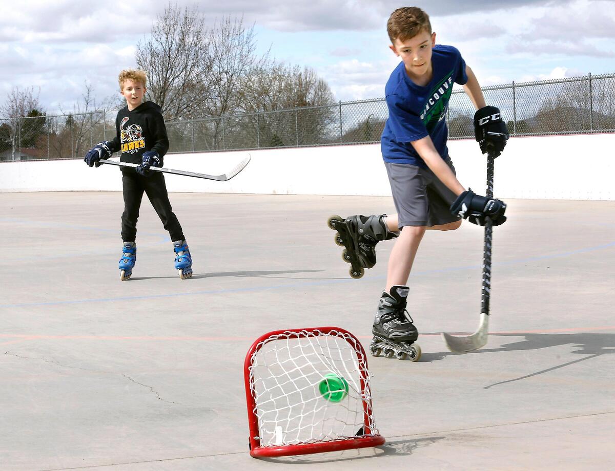 Jackson Rowland, 12, fires the puck into a mini practice net on a breakaway while playing with his brother, Ryan, 10, at the outdoor roller hockey rink in Kennewick. “I had to get them out of the house for spring break. They’ve been cooped up for too long,” said their mother Tiffani Rowland, who drove them from Grandview. The two play competitive ice hockey for the Yakima Hawks.
