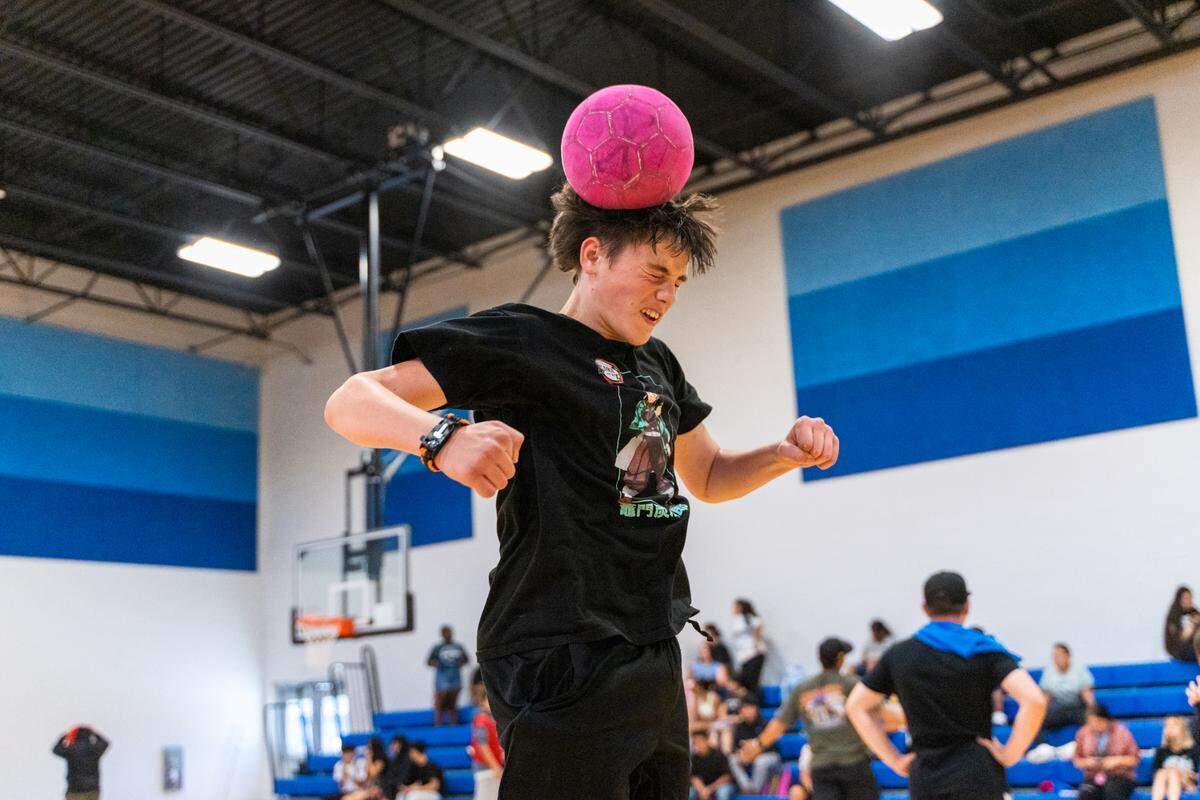 A player heads the ball during an intramural soccer match with the Boys and Girls Club.