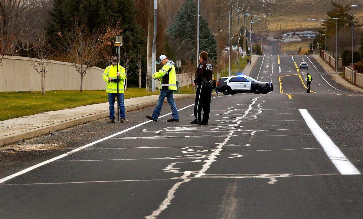 Kennewick city surveyors helped police traffic officers Wednesday measure the scene of a fatal crash Dec. 27 on South Ely Street.