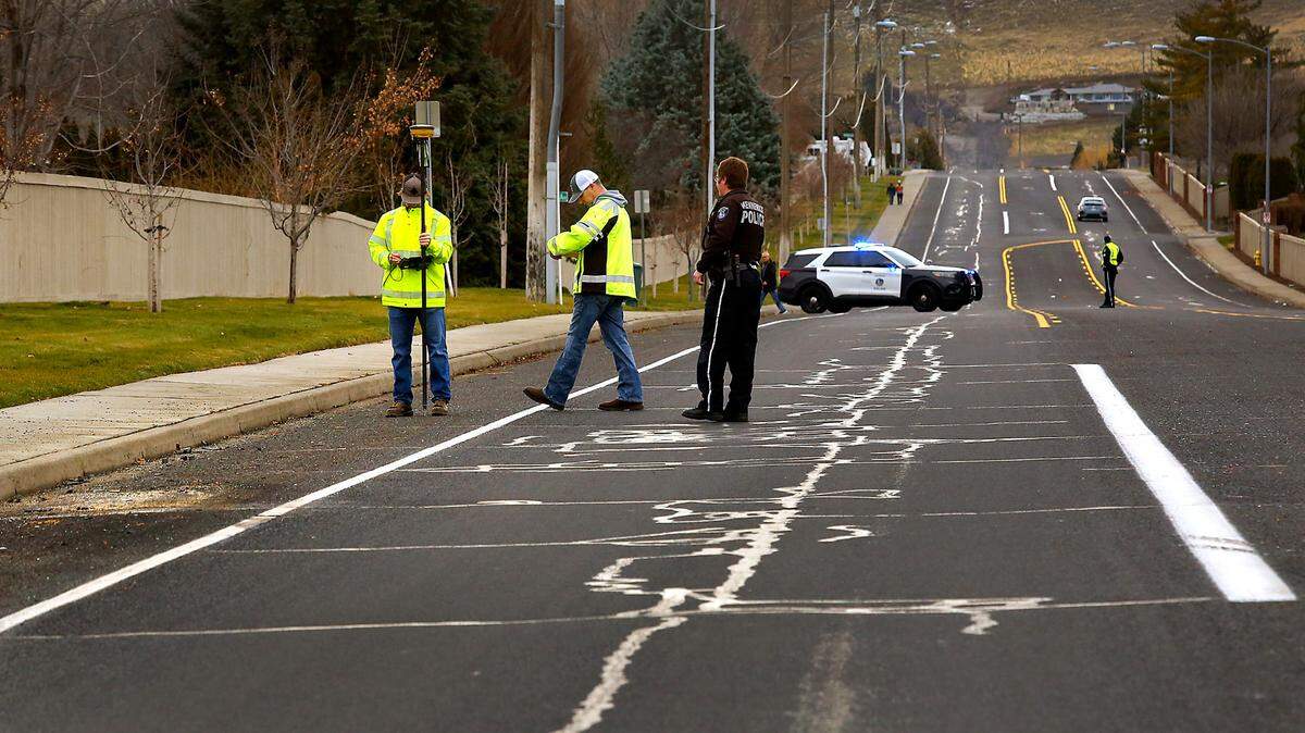 Kennewick city surveyors helped police traffic officers Wednesday measure the scene of a fatal crash Dec. 27 on South Ely Street. The investigative markings on the pavement were covered with snow and ice until this week. Driver Angel Mendoza, 25, died at 7:18 p.m. at the site after losing control of his Mercedes and crossing into the oncoming lane, hitting a Jeep. Two people in the Jeep were seriously injured.
