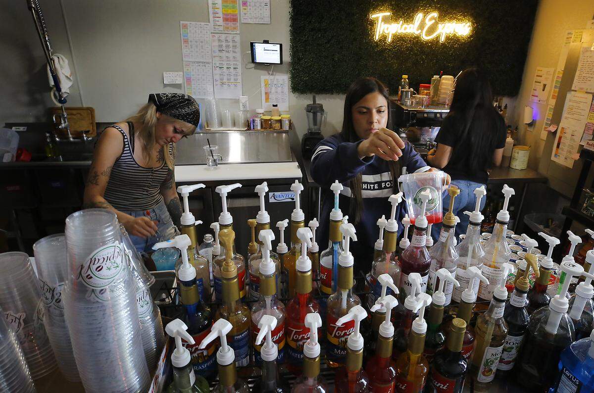 Employees at Tropical Express Coffee and Drink Bar Tania Castro, Brenda Zepeda and Estefanie Andrada, from left, make  colorful and flavorful drinks at the store's location on West Skagit Avenue in Kennewick. 