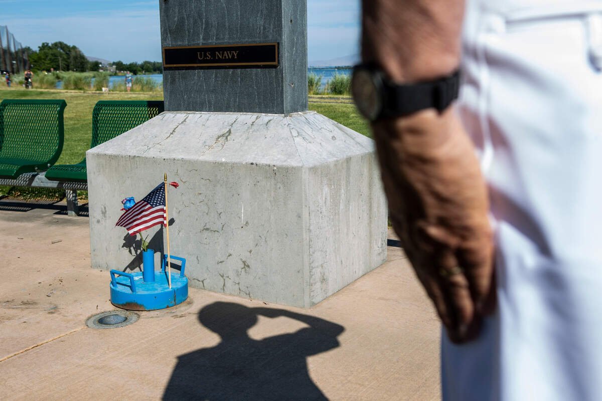 Retired Navy captain Craig Liebler, 72, salutes the memorial for Navy veterans in Columbia Park on the Fourth of July after watching the flyover of retired military aircraft. “I come down here every year and put flowers around,” Liebler said.