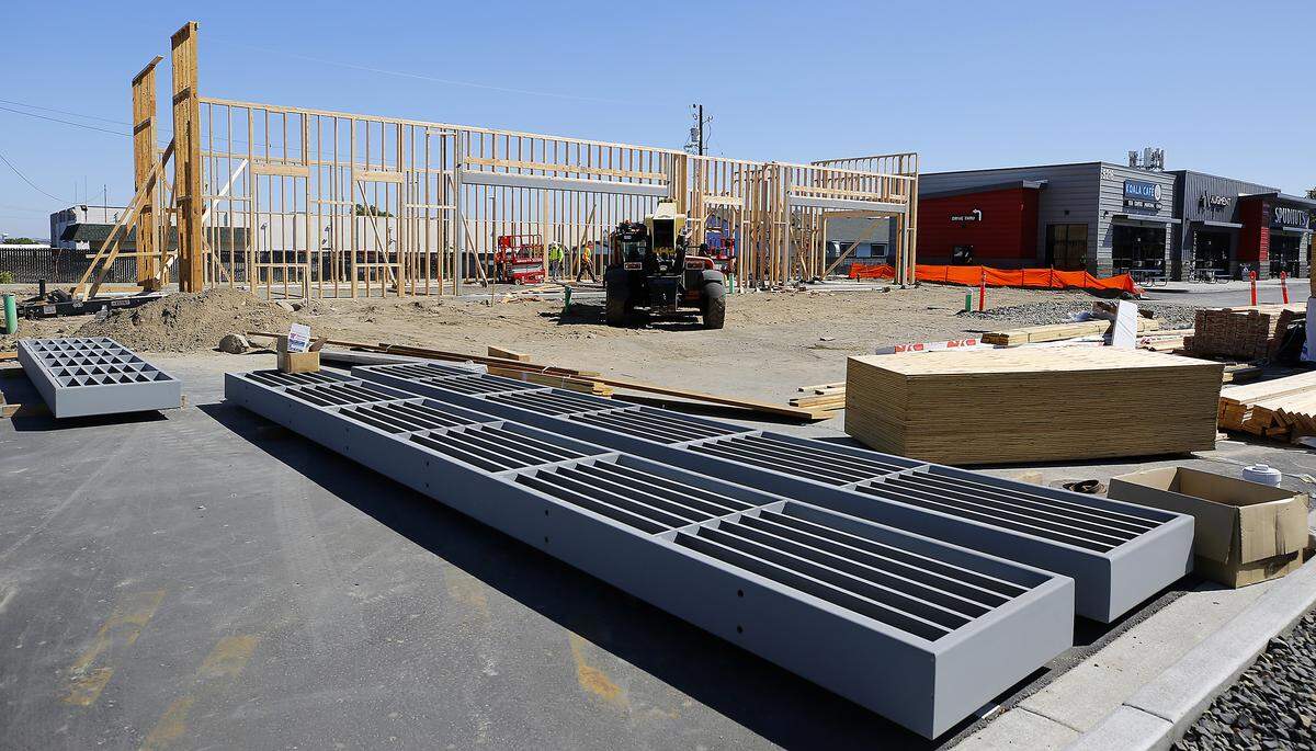 Construction crews work on the framing of a new retail building at 5222 W. Okanogan Place near Kamiakin High School in Kennewick.