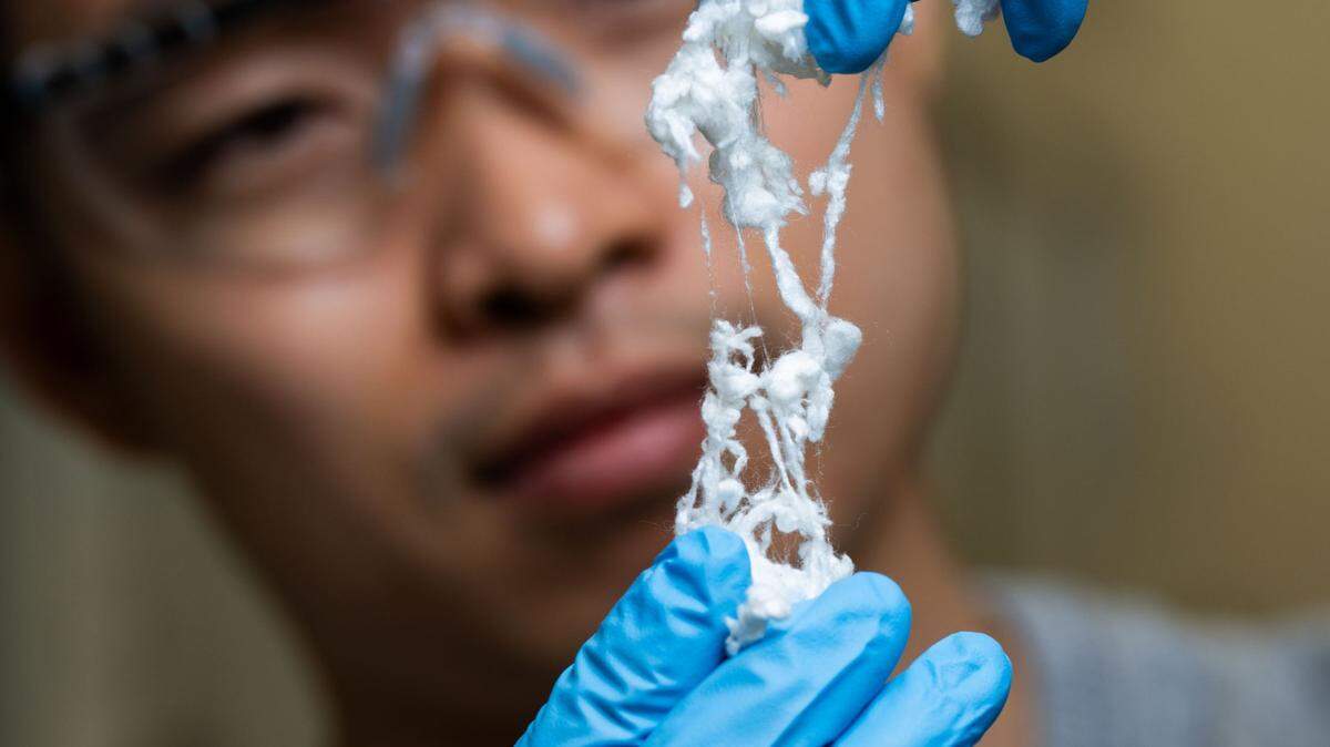 Chenyang Shi, a post-doctoral research associate at PNNL, is part of the research team advancing techniques that may make it possible to use silk fibers like those shown here in microelectronics such as tiny health sensors.